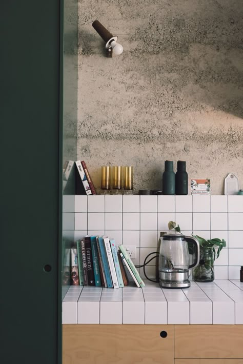 dark green with wood and raw concrete walls, large square white tiles, shelf above backsplash // fort & field Kitchen Wall Tiles, Bedding Stores, Eco House, Trendy Kitchen, Decor Minimalist, Kitchen Tiles, Cheap Home Decor, 인테리어 디자인, Interior Design Kitchen