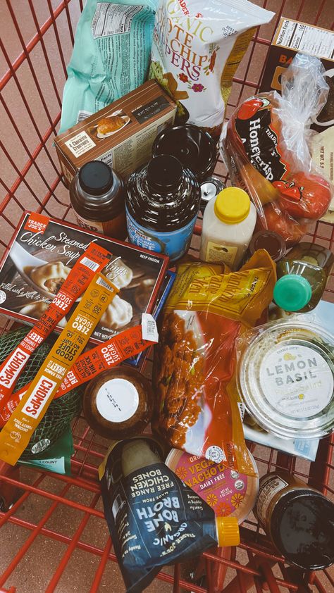 Picture is of a red shopping cart from Trader Joe’s filled with various food and beverage items such as soup dumplings, orange chicken, chocolate croissants, cold brew concentrate, and chai tea. Dumplings Trader Joes, Trader Joes Favorites, Grocery Shopping Healthy, Healthy Food Shop, Shopping Healthy, Soup Dumplings, Shopping List Grocery, Lemon Basil, Fall Things