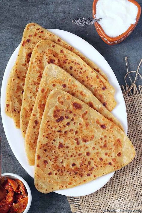 Detailed beginners guide to make perfect, flaky, and soft plain paratha recipe at home! The plain paratha, also known as Tawa Paratha is an Indian unleavened flatbread that can complement almost any dish and can be served with curry, pickle, raita, curd, pickle, chutney, or also make a great accompaniment with a hot cup of chai. In the recipe post, I shared step-by-step how to make plain parathas in 3 shapes – triangle, round, and square. #paratha #indian #flatbread #howto #simple #plain #curry Plain Paratha, Indian Flatbread, Paratha Recipe, Paratha Recipes, Indian Bread, Garlic Butter Chicken, Dry Snacks, Healthy Homemade Recipes, Tasting Party