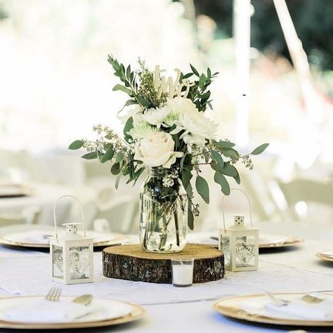 Simple Rustic Floral Centerpieces, Greenery And White Flowers Wedding Table, Wedding Bouquet Table Centerpiece, White Rustic Centerpieces, Elegant Mason Jar Centerpieces, Sage Green Flower Centerpieces, Floral Mason Jar Centerpieces, Mason Jar Greenery Centerpieces, Rustic Wedding Table Flowers