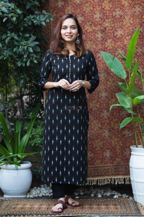 Tailored out of 100% premium cotton, arit is a poetry of elegance with its exquisite ikat print. The base is adorned with black ikat print giving a timeless monochromatic look. The smart front button round neckline, with 3/4sleeves, and functional pocket elevate its smartness. Pair it with our black cotton pants for a beautiful cohesive look. Black Cotton Kurti Design, Black Ikkat Kurti Designs, Ikat Suit Designs, Ikat Kurta Designs Cotton, Ikat Kurti Designs, Black Kurti Design, Plazo Kurti Design, Ikkat Kurti Designs, Formal Kurti