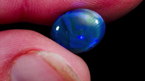 Natural Australian Black Opal GemstoneThis striking Oval shaped Black Opal was Sourced from Lightning Ridge, NSW, AustraliaAustralian black opal is the most precious and valuable type of opal. Radiating a myriad of dark black hues and flashes of vibrant electric blues,