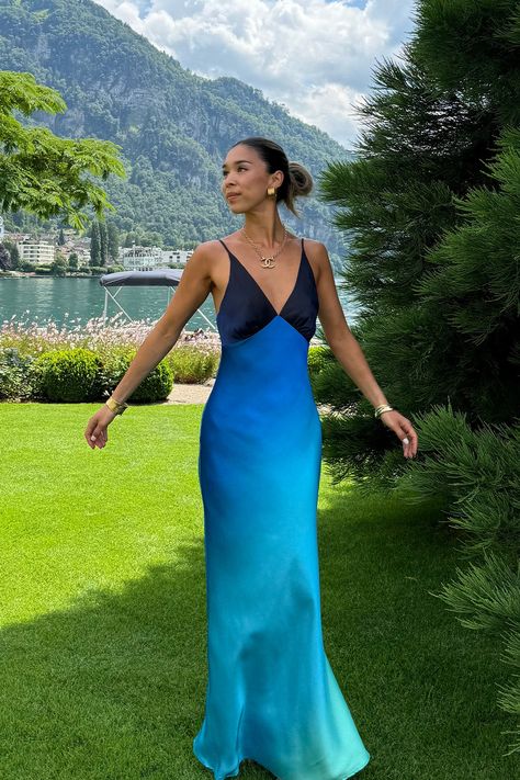 A Mirabella for you and your bestie. For our besties who love the sunset, the Mirabella Blue Satin Sorbet Maxi Dress is for you. Featuring an ombre that begins with a deep cobalt blue plunging v-neckline that cascades down into a aqua colored hemline, the Mirabella Blue Satin Sorbet Dress is fun, flirty and so flattering. Pair with your bestie wearing the Mirabella Pink Satin Sorbet Maxi Dress for an unstoppable dress duo guaranteed to make memories together. Luxury Blue Bridesmaid Maxi Dress, Luxury Blue Evening Dress For Spring, Luxury Blue Spring Evening Dress, Beach Photoshoot Formal Dress, Luxury Blue Summer Evening Dress, Unique Final Blue Dress, Beach Wedding Guest Dress Summer Low Back, Duo Color Dress, Luxury Blue Gown For Spring