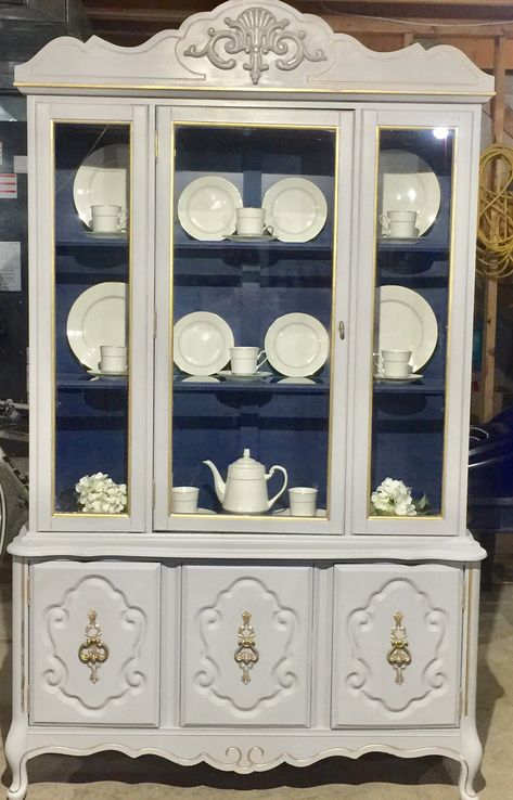 Vintage china cabinet, painted in Grey, bunker hill blue, and trim and details in gold. Colours inspired from Karen Lebere designs. Painted China Hutch, China Cabinet Painted, Cabinet Styling, Vintage China Cabinet, Redone Furniture, 2025 Design, Vintage China Cabinets, Light Paint Colors, Painted China Cabinets