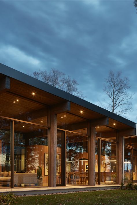 Mass timber house made of glued-laminated timber (GLT) offering a remarkable view of the lake and its surroundings thanks to its exceptional fenestration. Photo Credit: Maxime Brouillet Mass Timber House, Mass Timber Architecture Exterior, Heavy Timber Architecture, Timber House Design, Modern Timber House, Modern Chalet Architecture, Mass Timber Architecture, Wood Modern House, Modern House In The Woods