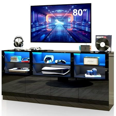 Blotout 80-inch TV cabinet with a high-gloss finish and RGB LED light, infusing modern technology into the living room and showcasing luxury and uniqueness. It not only fits 60-inch, 65-inch, 70-inch, and 75-inch TVs, but also 80-inch plasma wall-mounted TVs. The spacious top provides ample room for displaying cherished mementos, picture frames, vases, and other decorations, keeping the room tidy and organized. The lighting on this LED TV stand transforms to match the colors of the music, adding Gaming Entertainment Center, 70 Inch Tv Stand, Tall Tv Stands, Tv Stand With Led Lights, Console Table Black, Tv Console Modern, Tv Entertainment Centers, Modern Tv Cabinet, Media Console Table