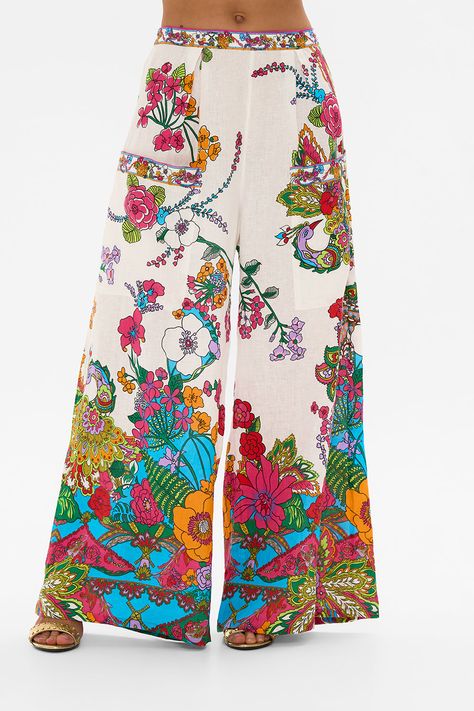 The Cosmic Prairie Wide Leg Trouser With Front Pockets wanders through a garden of vibrant retro florals that radiate against the vivid white backdrop. A luxury CAMILLA silk pant that features a relaxed wide leg silhouette upon the high waistline. The adjustable waistband and patch pocket details exude effortless wearability. Explore more from the Wonderkind collection. Floral Wide Leg Trousers, Silk Pant, Fashion Trend Forecast, Trend Forecast, White Backdrop, Silk Pants, Baby Sale, Adjustable Waistband, Trend Forecasting