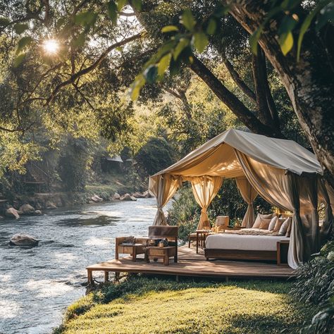 🌿✨ Unwind in Riverside Luxury: Glamping in Thailand’s Lush Forests ✨🌿 Imagine waking up to the soothing sound of a flowing river and the gentle sunlight filtering through a canopy of trees. This luxurious riverside glamping retreat in Thailand is truly breathtaking—a photorealistic scene right out of a dream. 📸 Step into elegance with a spacious tent, featuring a wooden bed framed by soft white curtains, plush sofas under airy canopies, and a cozy outdoor seating area. The setup is complete... Forest Resort Ideas, Glamping Retreat, Cozy Outdoor Seating, Glam Camping, Forest Resort, Flowing River, River Cabin, Outdoor Seating Area, Luxury Glamping