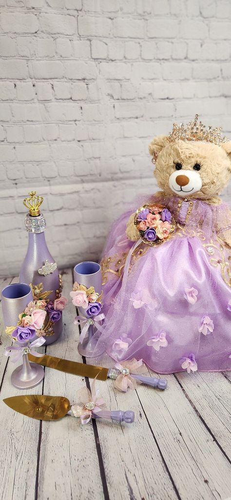 Packages: Complete package includes: 🧸 Quinceanera Bear or Doll (Includes bear or doll, Dress, Petticoat, Jewelry, Metal Tiara, Bouquet, Doll stand, Personalized ribbon) 👸🏻 Tiara upgrade for Bear/Doll  🧸 Doll stand for the Bear/Doll  ️ Kneeling Pillow  👸 Tiara Pillow 📖 Guest Book 🖋️ Pen 📕Bible 🕯️Candle 📷Photo Album 💵Card/Money Box (Acrylic also available for additional cost) 🥂🍾Small Brindis Champagne Set (2 glasses & 1 bottle) 🍰Cake Serving Set ✍🏻 Personalization on items ✍🏻 Ribb Centerpieces For Quince Purple, Quince Doll Purple, Rapunzel Quinceanera, Purple Quince Decorations, Rupunzel Quince Theme, Sweet 16 Tangled Theme, Repunzel Quince Theme, Rapunzel Theme Quinceanera, Tangled Theme Quinceanera