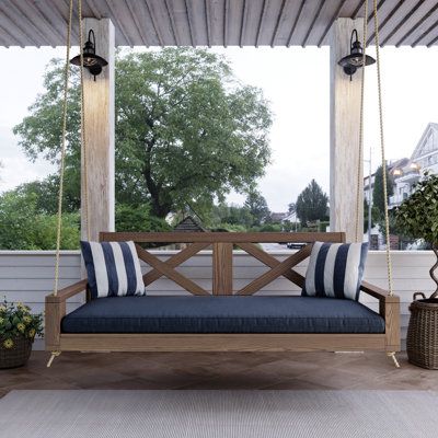 The Amish Casual Malvern Swing Bed is the ultimate in outdoor comfort. Handcrafted in the USA by Amish craftsmen, this daybed-style swing bed is constructed of grade-A kiln-dried pine for exceptional durability and strength. With a heavy-duty design that supports up to 800 lbs. your family can enjoy relaxing nights on the porch together. Amish Casual Overall Width: 75", Frame Color: Oak Stain | Amish Casual Malvern Porch Swing Bed 27.5 H x 75.0 W x 47.0 D in green in Oak Stain | 75" | Wayfair Porch Swing Ideas, Daybed Styles, Lake Condo, Porch Swing Bed, Swing Bed, Farmhouse Bench, Outdoor Comfort, Bed Swing, Oak Stain