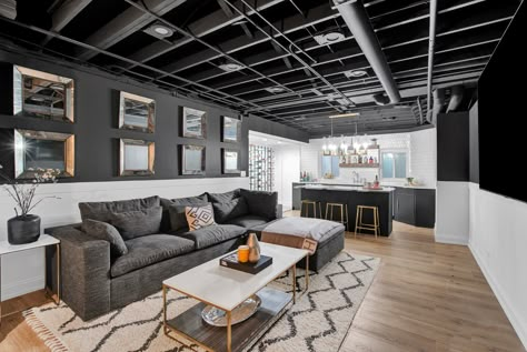 Gray Painted Basement Ceiling, Black Exposed Ceiling Basement, Gray Exposed Basement Ceiling, Black Unfinished Basement Ceiling, Modern Basement Apartment, Black And Grey Basement Ideas, Finished Basement Black Ceiling, Black And Gray Basement, Basement With Grey Flooring