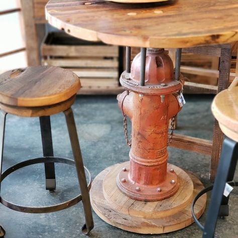 This is a one-of-a-kind table you won't find anywhere else! Built from an old fire hydrant, this bar table would look great in your basement or patio!  #ReclaimRenew #firehydrant #bar #basement #bartable #cool Firehouse Decor Ideas, Fire Truck Bar Ideas, Firefighter Man Cave Ideas, Firefighter Bar Ideas, Fire Hydrant Table, Fire Chief Office Ideas, Fire Hose Furniture, Fire Hose Decor, Old Fire Hydrant Ideas