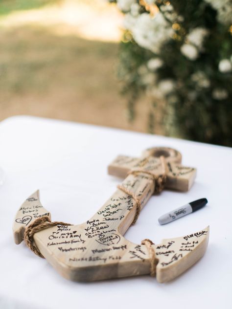 Skip the traditional guest book and have attendees sign something thematic, instead. At this wedding planned by Bridal Bliss, celebrants wrote on a wooden anchor. Beach Wedding Guest Book, Wooden Anchor, Wedding Guest Book Ideas, Halloween Wedding Cakes, Guest Book Ideas, Literary Wedding, Catholic Wedding Ceremony, Anchor Wedding, Inexpensive Wedding Favors