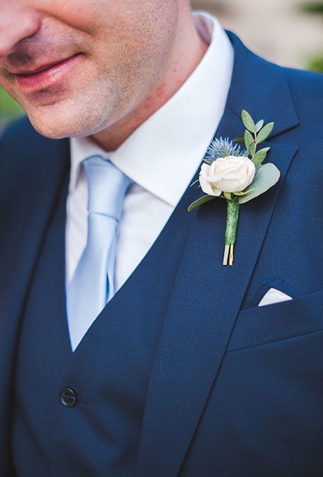 Spring Boutonnieres | Brides Wedding Flowers White Roses, Romantic Villa, Thistle Boutonniere, White Rose Boutonniere, Blue Boutonniere, White Boutonniere, Wedding Flowers Roses, Rose Boutonniere, Villa Wedding