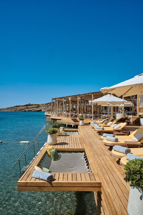 A chic beach getaway destination tucked away in a cove with views of Bodrum’s old town. The multi-room villas are perfect for groups of friends. The open-air deck at Folie Beach restaurant is a popular spot for soaking up the sun, too, and the over-water hammocks add an extra touch of luxury. #turkeyluxuryhotel #luxuryhotelsturkey #bodrumturkeyhotelluxury #bodrumhotelluxury #bodrumturkeybeach #bestresortsinbodrum #bestplacestostayinbodrum #turkeyluxurybeachresort Beach Hotel Design, Bodrum Restaurant, Luxury Vacation Spots, Bodrum Beach, Beach Dock, Luxury Beach Vacation, Turkey Beach, Luxurious Resort, Hotel Beach