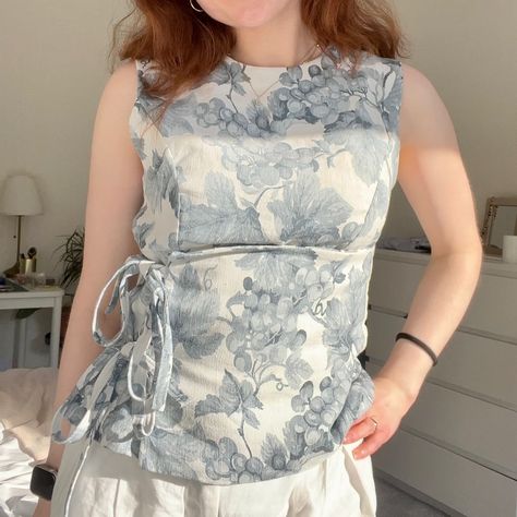 an upcycled table cloth into this cute top🫶🏻 ✨ Pattern: SundaySchoolPatterns on Etsy 🧵 Material: floral tablecloth from charity shop - £4 🪡 Adjustments: Only thing I did was take each front panel in by 1cm for a more fitted look 📍Machine: Elna Experience 540 🤍 Overall v v happy, I love this tablecloth and think the top is super cute ☺️ #sewing #sewingproject #sewist #sewistsofinstagram #sewingblogger #sewingblog #makingclothes #handmadewardrobe #sewinginspo #sewingtutorial #sewingpattern Upcycled Tablecloths, Upcycled Table, V Happy, Upcycle Table, Slow Fashion Movement, Handmade Wardrobe, Floral Tablecloth, Sewing Blogs, Charity Shop