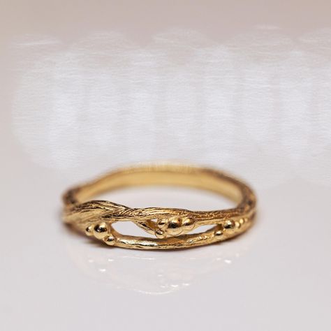 A 14K gold unique branch ring. This ring is made from two gentle entwined branches with tiny gold dots that grow out like the beginning of blooming fruits! This piece is made by hand in our studio and can be adjusted in shape and price according to your budget and wishes; contact us for more information. * Material: 14K Solid Gold * Gold Color: Yellow Gold, White Gold, Rose Gold * All of our jewelry is handmade, so there might be a slight difference between each piece * If you can't find the information you need or have any special requests, please contact us. We are quick to reply :) ♡ Follow our shop ♡ https://www.etsy.com/il-en/shop/kwintnerJewels?ref=seller-platform-mcnav Branch Wedding Ring, Branch Wedding Band, Fruit Branch, Gold Twigs, Twig Engagement Ring, Branch Ring, Gold Color Ring, Etsy Wedding Rings, Gold Dots