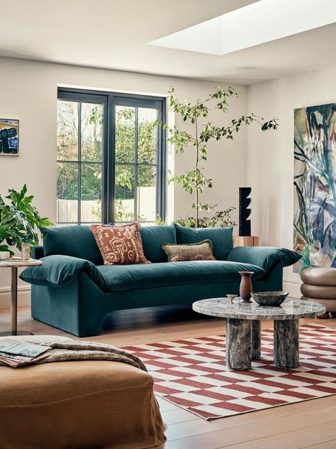 A teal sofa is a striking and vibrant centerpiece for any living room. Its rich and deep shade of blue-green adds a sense of depth and character to the space. The bold color instantly grabs attention and infuses the room with a refreshing energy. Whether placed against a neutral backdrop to create a focal point or surrounded by complementary or contrasting colors, the teal sofa exudes a sense of elegance and style. Its versatility allows for various design options, from coastal-inspired decor Navy Velvet Couch, Soho Warehouse, Navy Couch Living Room, Blue Velvet Sofa Living Room, Navy Sofa Living Room, Teal Sofa Living Room, Navy Couch, Relaxed Glamour, Navy Velvet Sofa