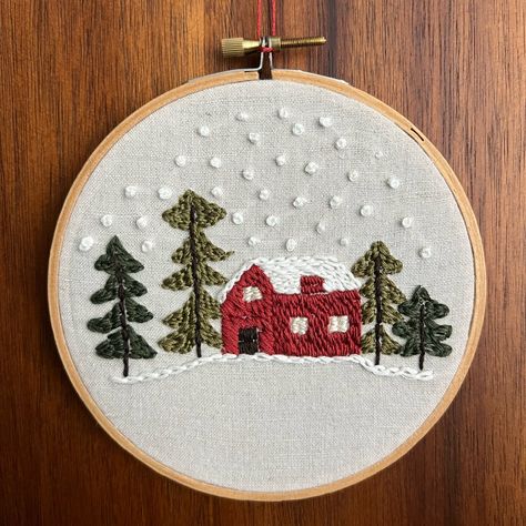 Handmade Embroidery Hoop Art Scene Of A Red House Surrounded By Green Pine Trees On A Snowy Day. Stitched On Reclaimed Linen (A Thrifted Blouse) With A Wooden Frame. 5”X5” Thrifted Blouse, Scene Embroidery, Embroidery Christmas Gifts, Silhouette Mint, Christmas Hand Embroidery, Chinese Wall Art, Framed Botanical Prints, Felt Wall Hanging, A Snowy Day