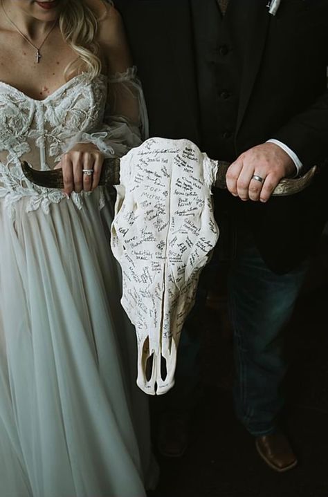 Signed steer skull as a guest book! Photo by: Courtneylynn Photography Country Wedding Guest Sign In, Gothic Wedding Guest Book Ideas, Cow Skull Signing Wedding, Country Meets Goth Wedding, Bull Skull Wedding Sign In, Deer Skull Wedding Decor, Skull Guest Book Wedding Ideas, Spooky Western Wedding, Cow Skull Guest Book