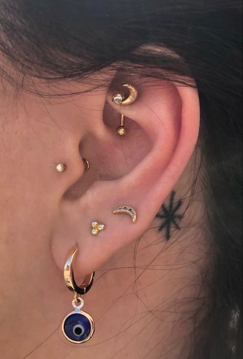 piercings Ear Piercings Evil Eye, Curated Ear Piercing Green, Astrology Piercing Ear, Ear Piercing Curation, Curated Ear Piercing Maximalist, Piercing Curation, Ear Piercings Celestial, Piercing Inspiration, With Tattoo