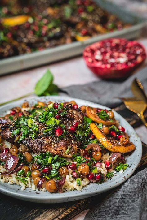 Pomegranate chicken is a sheet pan meal that highlights the sweet and tart flavors of winter pomegranate on crispy, oven-roasted chicken thighs. A blend of spices and a flavorful marinade transform simple chickpeas and chicken into a complete meal that pairs beautifully with fresh herbs and whole grains. #chicken #sheetpan #dinner #pomegranate #chickpeas Chicken Sheetpan Dinner, Roasted Chickpeas Salad, Pomegrante Salad, Pomegranate Chicken Recipes, Zaatar Chicken, Oven Roasted Chicken Thighs, Roasted Chickpea Salad, Chickpeas Salad, Chicken Sheet Pan Dinner