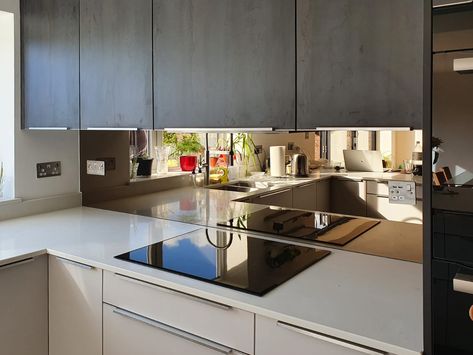 Bronze mirror shown here installed by Southern Counties Glass in a modern kitchen. Kitchen Mirrored Backsplash, Bronzed Mirror Splashback, Kitchen Mirror Splashback Ideas, Smokey Mirror Splashback, Bronze Mirror Splashback Kitchen, Backsplash Mirror Kitchen, Mirror Behind Kitchen Sink, Mirror In Kitchen Ideas, Bronze Splashback Kitchen