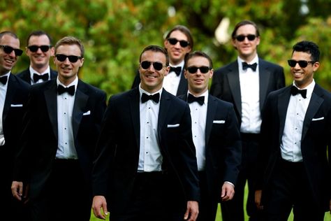 Groom and groomsmen in black tuxedos, bow ties, sunglasses, white pocket squares Moodboard Wedding, White Pocket Square, Pocket Square Wedding, Groomsmen Bowtie, Black And White Tuxedo, Groomsmen Photos, Rustic Wedding Bouquet, Handsome Groom, Lakeside Wedding