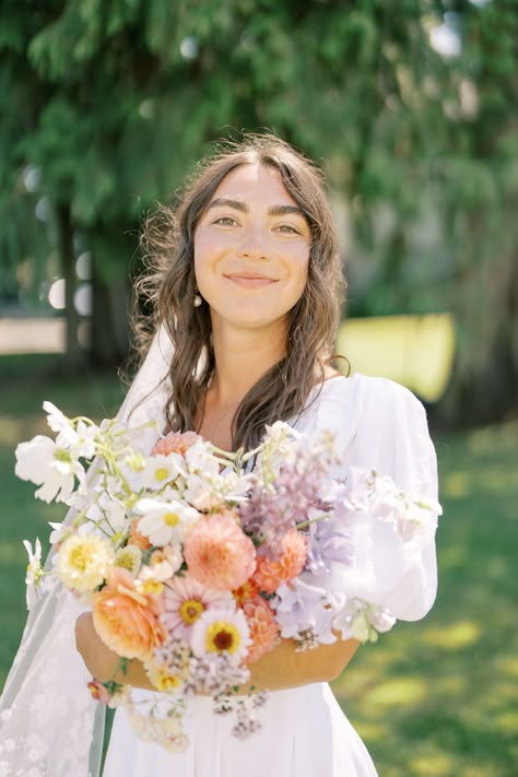 We created this stunning bridla bouquet by working with flowers that captured the essence of summer through their vibrant colors and textural elements in including cosmos, dahlias, zinnias, sweet peas, phlox, pansies, larkspur, nicotiana, flowering oregano and more. Bouquet With Sweet Peas, Cosmos Wedding Bouquet, Summer Wedding Flower Arrangements, Wildflower Summer Wedding, Romantic Arrangements, Vibrant Summer Wedding, Zinnia Bouquet, Summer Bridal Bouquet, Summer Wedding Centerpieces