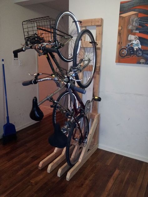 Vertical Bike Rack from 2x4s - space saver and you don't have to put holes into your wall. Probably will modify for my uses. Townie Bike, Standing Bike Rack, Hanging Bike Rack, Officine In Garage, Rack Velo, Vertical Bike Storage, Diy Bike Rack, Bike Humor, Vertical Bike Rack