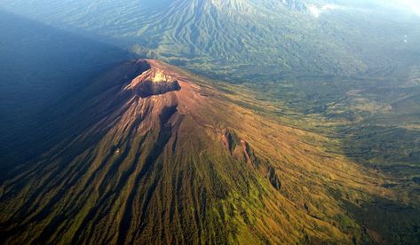 Mount Agung is a volcano found in Bali, Indonesia and is also sometimes called Gunung Agung. It is an active stratovolcano and is notable for not only being the highest point on the island of Bali, but also for having a serious impact on weather patterns in the area, particularly concerning rainfall. Mount Agung measures approximately 3,033 km above sea level and is the fifth highest volcano in all of Indonesia, a country home to an estimated 130 active volcanoes. Mount Merapi, West Sumatra, East Java, Active Volcano, Tropical Destinations, Weather Patterns, Lombok, Day Hike, Holiday Rental