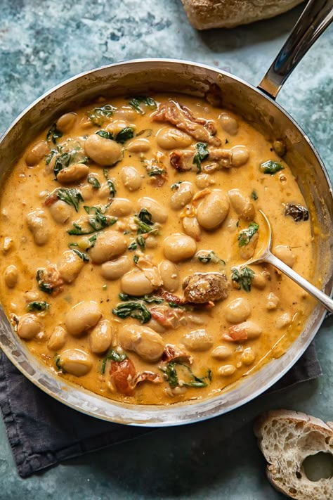 Tuscan Butter Beans with Spinach and Sun-dried Tomato Mediterrean Dinner, Creamy Tuscan Marry Me Butter Beans, Tomato Butter Beans, Tuscan Beans Recipe, Butter Beans And Sausage, Tuscan Bean And Kale Soup, Cafe Sandwiches, Sundried Tomato Butter Beans, Tuscan Beans