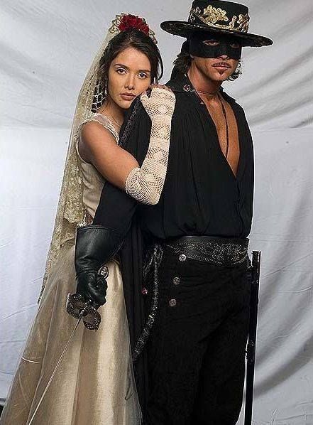 Christian Meier as Zorro and Marlene Favela as Esmeralda Sanchez de Moncada. Masquerade Couple Outfit, Elena Zorro Costume, Zorro And Elena Costume, Zoro Couple Costume, Catherine Zeta Jones Zorro Costume, Zorro Couple Costume, Mask Of Zoro Couples Costume, Female Zorro Costume, Couple Halloween Costumes Movies