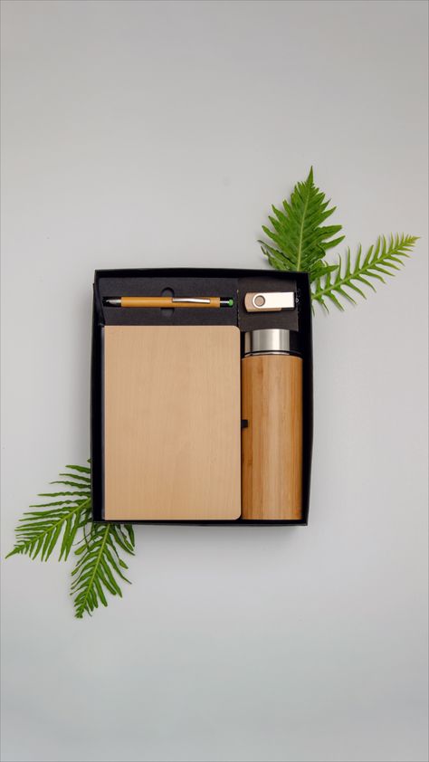 This gift box contains items made with bamboo. The gift hamper includes
An insulated bamboo bottle
A bamboo cover recycled paper notepad
Bamboo pen
8GB Pen drive Box Photoshoot, Bamboo Bottle, Client Gift Box, Corporate Branded Gifts, Bamboo Gifts, Pen Gift Box, Bamboo Pen, Desk Gifts, Box Packaging Design