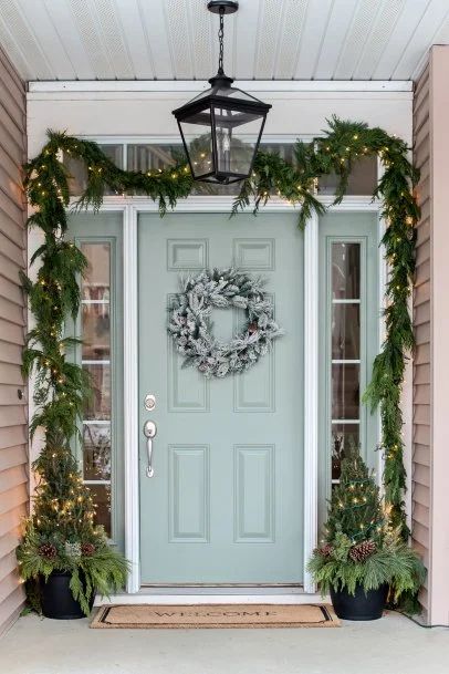 How to Hang Christmas Garland Around the Front Door | HGTV House Exterior Ranch, Potted Evergreens, Christmas Lights On House Exterior, Christmas Lights On House, Evergreen Planters, Exterior Christmas, Christmas House Lights, Front Gardens, Christmas Planters