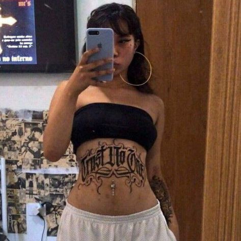 Stomach Name Tattoo, Old English Stomach Tattoo, Chest And Stomach Tattoo Female, Chicana Tattoo Design, Tight Tattoos, Lower Stomach Tattoos, Tummy Tattoo, Stomach Tattoos Women, Aztec Tattoo Designs