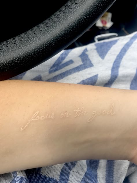 White tattoo Quote tattoo Small tattoo Arm tattoo White Tattoo Writing, White Ink Script Tattoo, White Ink Word Tattoo, Gods Child Tattoo, White Tattoo Aesthetic, White Hand Tattoo, White Tattoo Healed, White Ink Tattoo Ideas, Tattoo Small Quotes