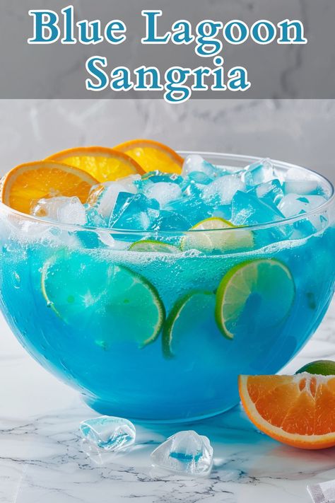 Blue Lagoon Sangria is a refreshing, vibrant cocktail that combines the crispness of white wine with the citrusy sweetness of blue curaçao and the effervescence of lemon-lime soda. Curacao Drink, Blue Curacao Drinks, Christmas Cocktails Easy, Easy Halloween Food, Blue Drinks, Yummy Alcoholic Drinks, Refreshing Drinks Recipes, Lemon Lime Soda, Festive Cocktails