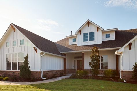 Red Brick White Board And Batten, White House With Red Brick Skirting, White House Brown Shingles, Red Brick With White Siding, Red Brick White Siding, Steel Siding House, White Siding Exterior, Grey House White Trim, Vertical Siding Exterior