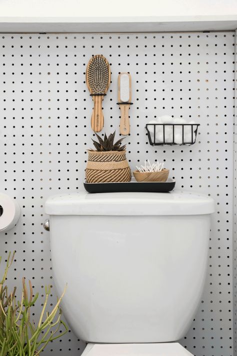 How To Install A Pegboard Wall to Add Storage and Style | Apartment Therapy Pegboard Bathroom, Pegboard Wall, Rental Bathroom, Plumbing Pipe Furniture, Style Apartment, Washroom Decor, Add Storage, Eclectic Furniture, Vintage Industrial Furniture