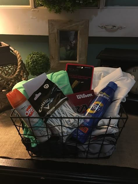 Golf basket for my husband's birthday. A couple outfits, sunscreen, bug spray, tees, golf balls, and a gift certificate for 18 holes and a cart for 2 people! He loved it! #golfbasket #golfer #bestwifeever #golfbirthday Golf Theme Basket Ideas, Golf Gift Basket Ideas Diy, Golf Auction Basket, Golf Gift Ideas For Boyfriend, Golf Birthday Gifts For Boyfriend, Golf Themed Gift Baskets, Boyfriend Golf Gifts, Golf Gift Basket Ideas For Men, Gift Ideas For Golfers For Him