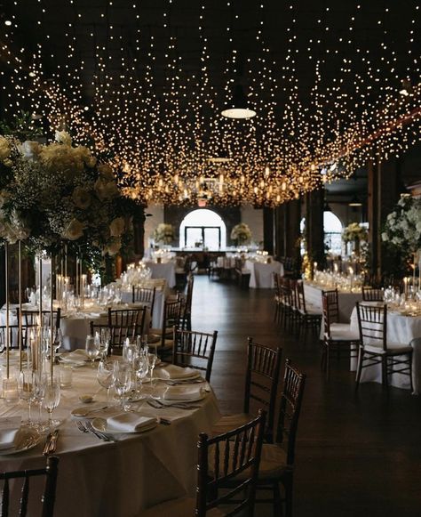 String Lights From Ceiling Wedding, Low Light Wedding Receptions, Twinkle Lights Wedding Indoor, Ambient Lighting Wedding Reception, Fairy Lights Wedding Reception Indoor, Diy Wedding Ceiling Decor, Wedding Feature Wall, Hanging Lights Wedding Reception, Wedding Venues Indoor Elegant