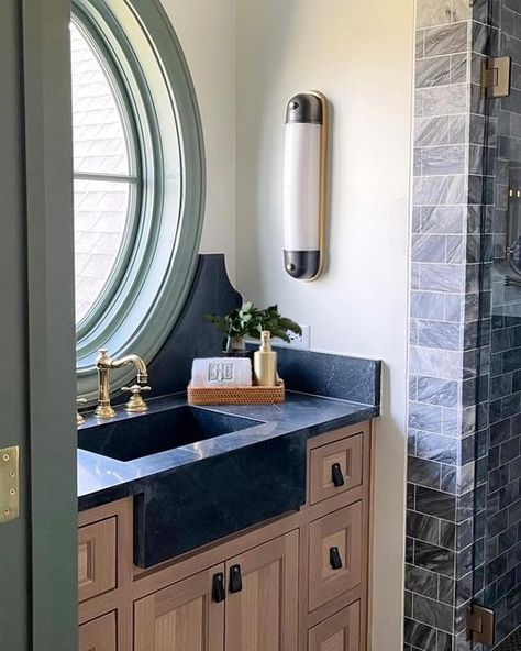 A Well Dressed Home | Designer on Instagram: "Today’s a good day for a peek into Beckham’s bathroom! 👀 You’ll notice a unique detail in this space! We opted for a less traditional layout by adding a swing mirror to the side wall, rather than above the vanity. This works perfectly for him & allows the oval window (+ view) to have a noteworthy moment! Ps- We’re crushing on this soapstone countertop, sink & curved decorative splash combo. 💚" Bathroom Vanity Side Splash, A Well Dressed Home, Traditional Layout, Soapstone Countertops, Oval Window, Boy Bath, Countertop Sink, Farmhouse Room, Window View