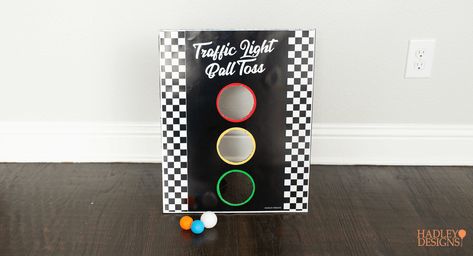 There's no need to reinvent the wheel. Take a new look at some classic games to make perfect DIY games and activities for your kid’s race car birthday. Instead of pin the tail on the donkey, there’s a printable pin the wheel on the car. Instead of regular-old ball toss, there’s a traffic light ball toss. There’s also a huge, race car track printable to color and play on. These are fun activities for any NASCAR, Formula 1, Hot Wheels, or Cars themed birthday party. Cars And Trucks Birthday Party Games, Race Car Party Games Activities, Car Games For Birthday Party, Race Car Diy Decorations, Hot Wheels Themed Birthday Party Games, Traffic Theme Party, Race Car Birthday Game Ideas, Games For Race Car Party, Cars Themed Birthday Party Activities