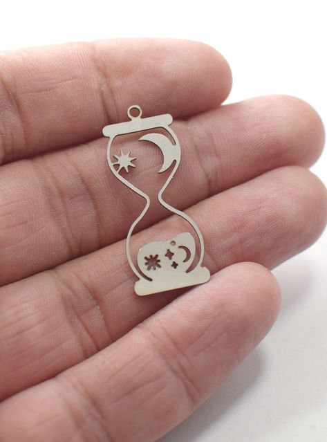 Laser-cut Stainless Steel Hourglass Charms & Earring Findings (0.6 x 13 x 33 mm) Laser Cut Necklace, Laser Cut Wood Crafts, Laser Engraved Ideas, Jewelry Design Drawing, Laser Cut Jewelry, Engraved Pendant, Jewelry Logo, Laser Engraving Machine, Jewelry Tags