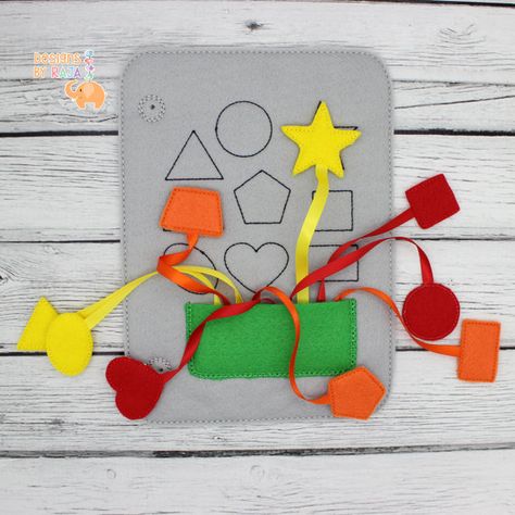 This cute shape matching busy book page is sure to keep your child entertained for hours! Match up the colored shapes with the shapes on the page! The pieces tuck away in the pocket at the bottom when you are done playing. Perfect for road trips, doctors office waiting rooms, airplanes, trains or anytime your little one needs something to keep him or her busy! This page fits with all of our other quiet busy book pages. It does not include a cover or rings which are listed separately. Mix and ... Quiet Book Pages, Book Shape, Busy Books, Learning Toys For Toddlers, Toddler Quiet Book, Shape Matching, Quiet Books, Hanukkah Gifts, Christmas Hanukkah