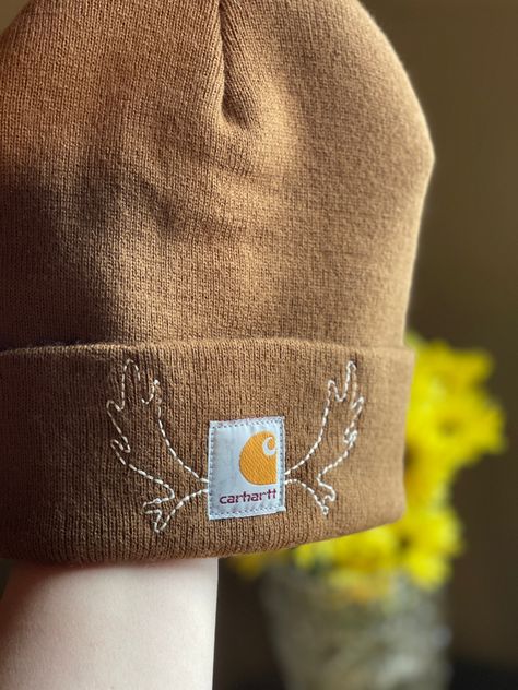 The reliable carhartt beanie, warm and  functional. Hand embroidered with Elk antlers.  Size, youth *every item in my shop is handmade which means there can be subtle variations and imperfections in my work. Winter Embroidered Beanie, Christmas Embroidery Ideas, Embroidered Carhartt, Etsy Clothes, Carhartt Beanie, Elk Antlers, Hand Crafts, Hand Embroidery Projects, Embroidery Gifts