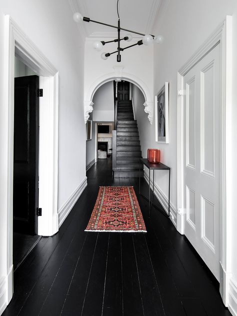 Maybe You Should Hide Your Bad Rental Floors #SOdomino #white #room #interiordesign #building #ceiling #floor #flooring #woodflooring #blackandwhite #stairs Monochrome Hallway, Black Wood Floors, Entrance Way, Dark Floors, Hal Decor, Interiors Online, Black Floor, Painted Floors, Hallway Decorating