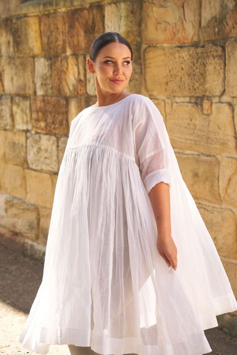 This Anouk tunic is made from a sheer and stiff cotton organdy.- Fine gathers at waist- Slip required- No pockets- Slouched sleeve design- Oversized fit MEASUREMENTS SIZE BUST BODICE LENGTH UPPER ARM AUS SIZE One Size 60 in 9 in 40 in 14 in 8 - 16 Lidiia is an Australian size 12 and 5'8'' wearing size O/S.Jenny is an Australian size 16 and 5'6'' wearing size O/S. If you don't love it, return it for a full refund. For a full view of our Return Policy click here. Free shipping within Australia. $1 Full Sleeves Design, African Inspired Clothing, Sleeves Designs For Dresses, Stylish Work Outfits, Oversized Dress, Fashion Sewing Pattern, Hippie Outfits, Cream Dress, Natural Fabrics