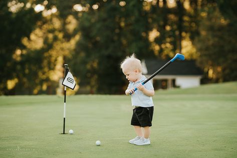 Little boy golfing on the course with a plastic golf club, sunset golf with kids, one year old golfing Golf 1st Birthday Photoshoot, Golf Newborn Pictures, One Year Old Golf Photoshoot, Family Photos On Golf Course, First Birthday Golf Theme Photos, Boys Golf, Golf Baby, Golf Pictures, Boys Playing